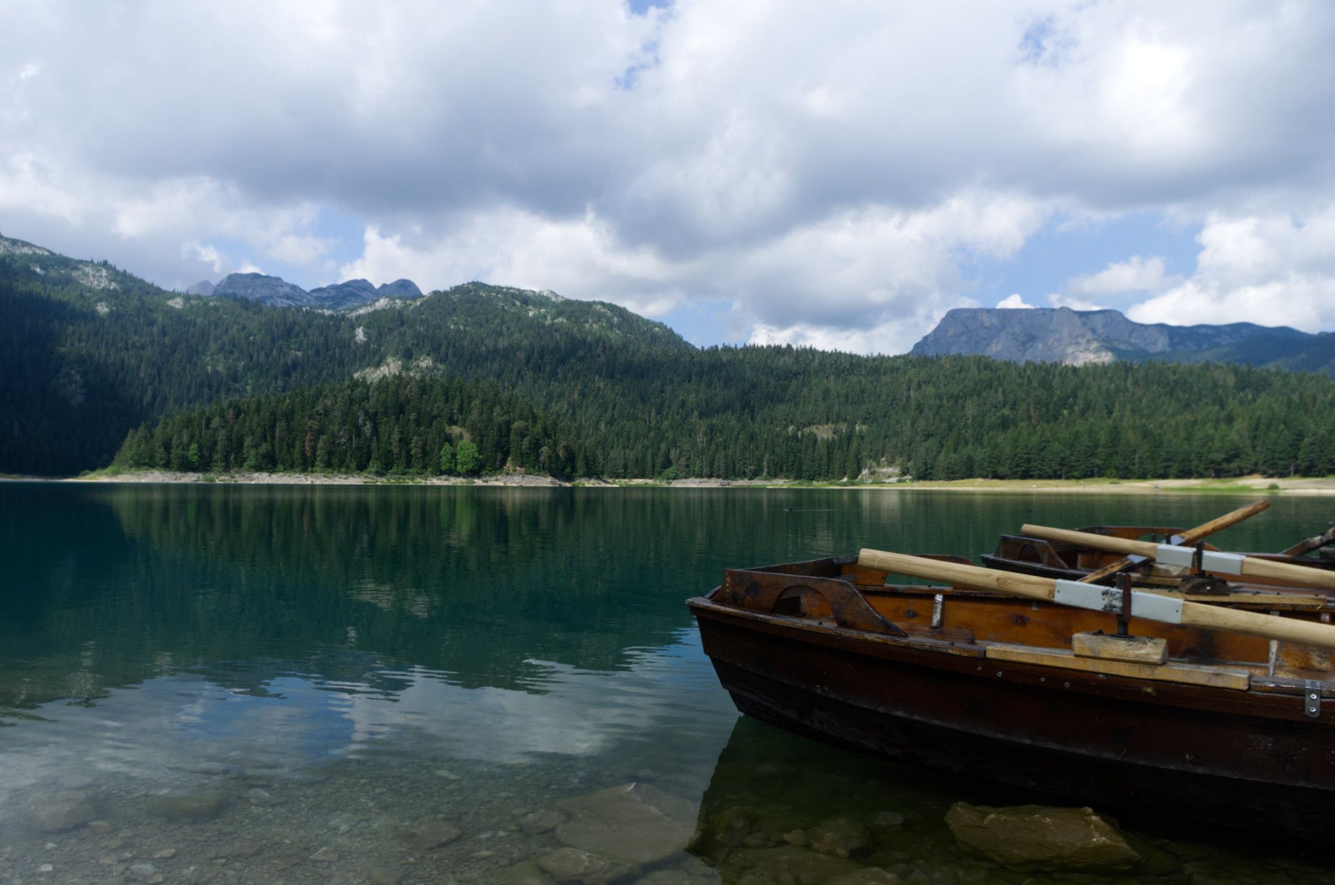 A photo of wooden boats on a lake